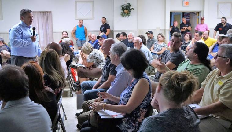 Gary Marmo, Elizabethtown Gas director of sales, on left, answers questions July 13 at the Ogdensburg public meeting about bringing natural gas to developments in the borough. (Photo by Vera Olinski)