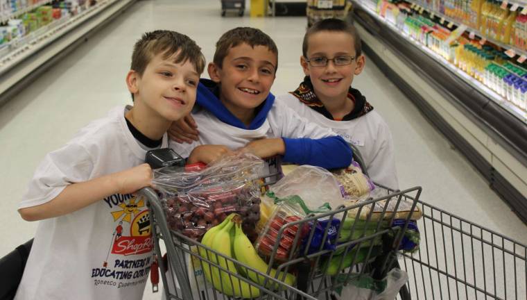 Paul Larsen, Joey Sugar, and Colby Palmer fill up their cart with nutritious food!