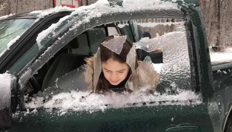 This photo by Laura White shows Lauren White, of Stillwater, has some fun with the ice during the storm.