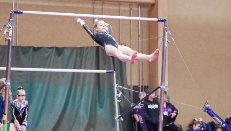 Sabrina Dispenziere (10) of Westy's Gymnastics performs on the uneven parallel bars.