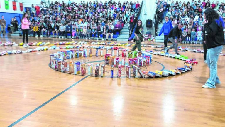 Cereal boxes set up in a circular formation fall down like dominoes. (Photo by Kathy Shwiff)