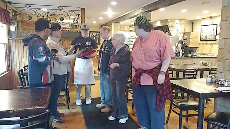 Two Milford eateries close because of Covid outbreaks John’s of Arthur Avenue is a community-minded restaurant. This photo from 2017 shows owner Colin Smith distributing tee shirts to visitors from Devereux Tristate Adult Day Care, who were treated to lunch and some pizza-making tips (File photo by Anya Tikka)