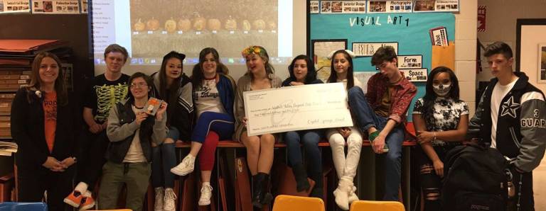 The class with their $1000 check from left to right: Art Teacher Amy Fairweather, Casey LeTellier, Molly Cheevers, Jessica Gieger, Beth Kabbash, Cassie Kull, Kayla Vangelakos, Marica Matlijoska, Connor Durand, Jada Martin and Jake Deanda.