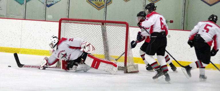 High Point-Wallkill Valley goalkeeper Nick Welch pushes the puck away.