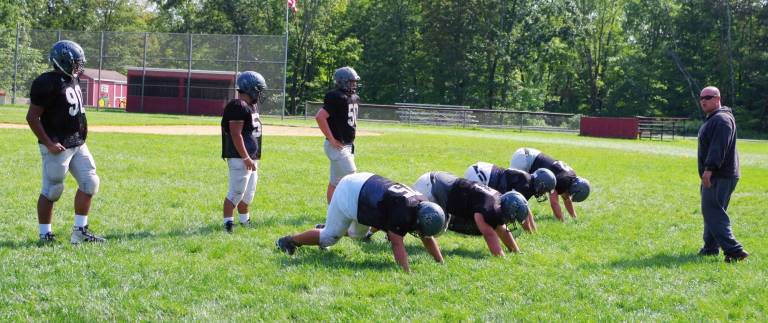During defensive drills Wallkill Valley Rangers listen to assistant football coach Adam Vazquez give instructions. The Wallkill Valley Regional High School (Hardyston, NJ) football team conducted morning and afternoon drills at Harmony Ridge Campground in Branchville, New Jersey on Thursday, August 24, 2017. The day was part of a week long stay at the campground. From August 20th to the 25th 2017 the Rangers ate, slept and sweated together in preparation for the upcoming season. The team has held practice sessions since June. The sleep away camp is a place for the team to work and have fun in a different setting other than at their school.