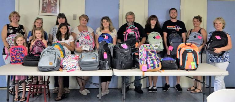 The volunteers and staff who assembled the backpacks for Ginnie's House.