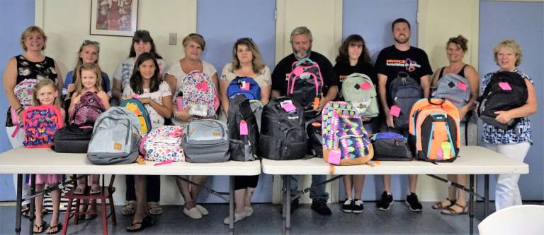 Vernon girl fills backpacks with school supplies for charity The volunteers and staff who assembled the backpacks for Ginnie's House.