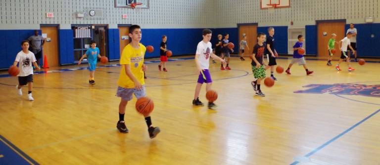 Crossroads basketball camp comes to area Crossroads Basketball Camp participants practice dribbling the ball.