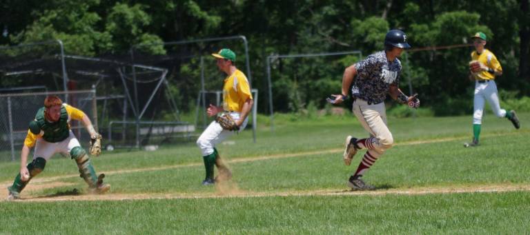 Franklin's runner Travis Hill moves towards first base as Denville fields the ball.