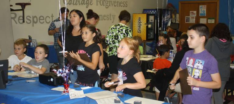 Ogdensburg school holds Literacy Night Mrs. Bieganousky and the Letelier family play a fun game of Boggle.