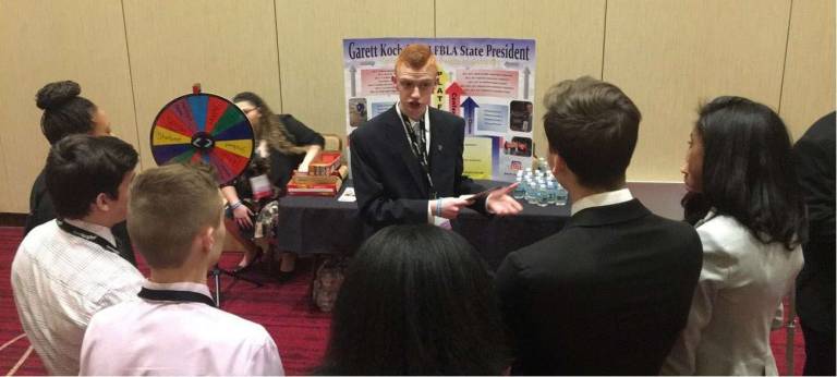 Garett Koch speaks with NJ members while campaigning for NJFBLA State President