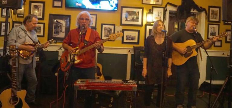 From left, Bob Marks, Ray Sikora, Beatty McArdle, and Brian McArdle sing and play at the Irish Cottage Inn.