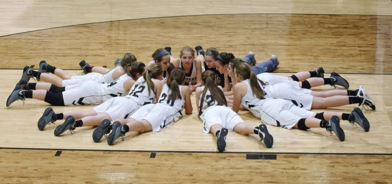 The Wallkill Valley Lady Rangers meet on the court before the start of the game.