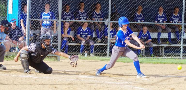 As her teammates watch, Kittatinny batter Allison Westra hits the ball.
