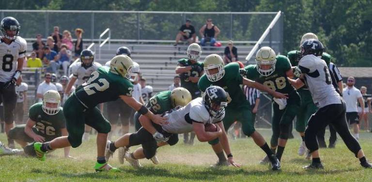 Sussex Tech linebacker Rich Hofmann (22) tackles Bergen Tech running back Michael Nowak.