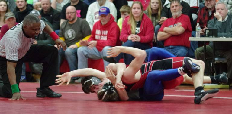 Kittatinny wrestlers defeat High Point An official keeps close watch on wrestlers.