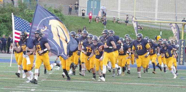 The Jefferson Falcons run onto the field carrying the American flag and their team flag. Hackettstown High School (Warren County, N.J.) defeated Jefferson Township High School (Morris County, N.J.) in varsity football on Thursday August 30, 2018. The final score was 7-3. The game took place at Jefferson Township High School.