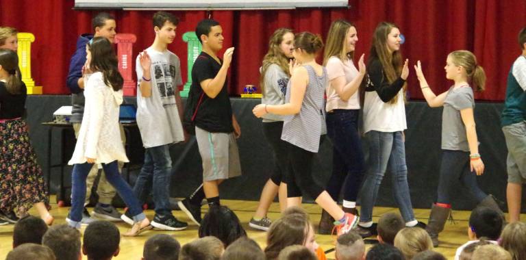 Students of the eighth and third grades share &#xfe;&#xc4;&#xfa;high fives&#xfe;&#xc4;&#xf9; during last Thursdays program at Hamburg School.