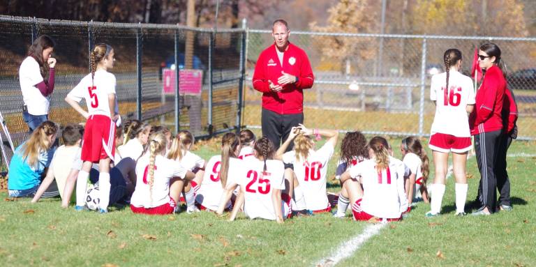 High Point head varsity girls soccer coach Aaron Berger speaks to the Wildcats during a break.