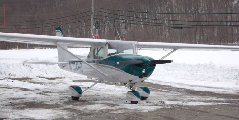 Photo by Vera Olinski A small plane waits to be towed after making an emergency landing on Route 23.