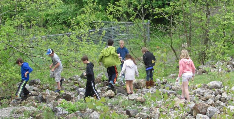 Kids in the rock field searching for treasures.