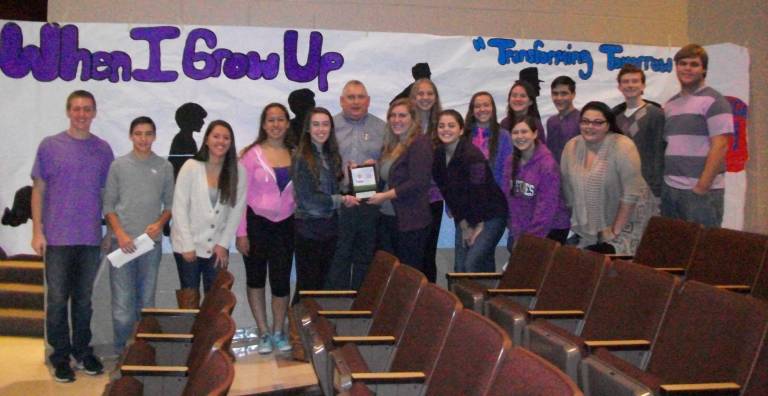 Matthew Rohsler, the 2014 Skylands March for Babies Chairman, (pictured in center) presents Community Service Vice Presidents Fiona Brown and Alexa Batelli and the Super Night Committee with the March of Dimes Top School Fundraising Award at the 2014 Super Night assembly on Nov. 12. Super Night 2014 will be held on Nov. 21.