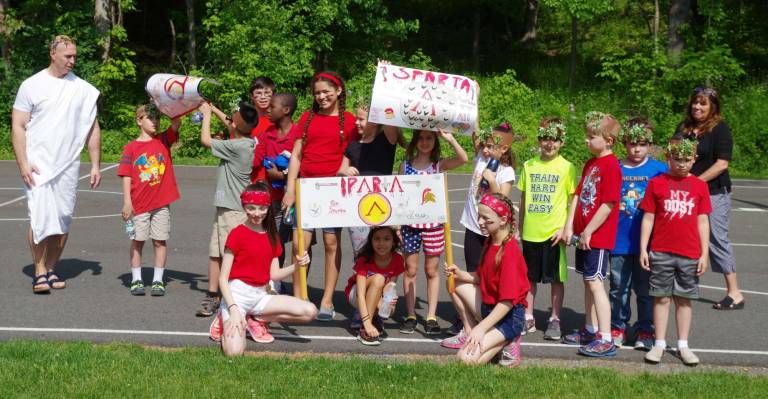 Hamburg hosts Greek Olympics At left and wearing a toga, Hamburg School history teacher Michael Blochinger stands with the members of the Sparta team during the Greek Olympics.
