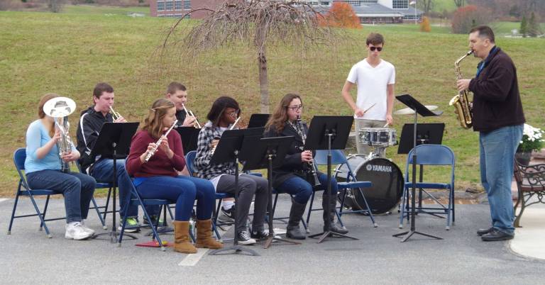 Members of the Wallkill Valley High School Band play the theme songs of the various military branches.