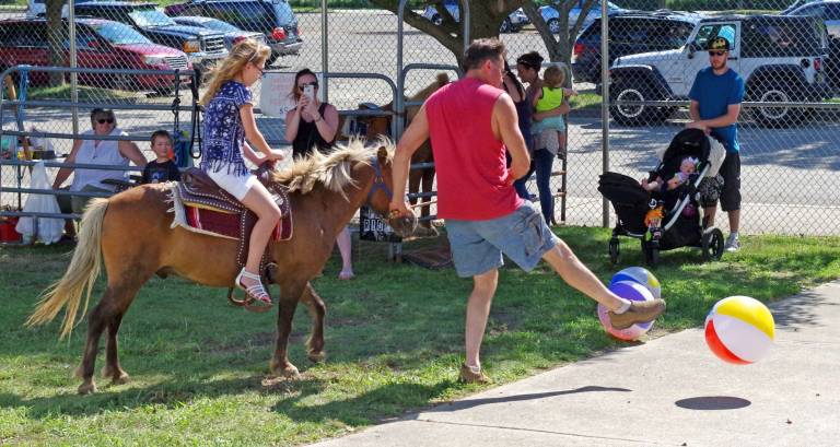 Where else but at the stadium would you find pony rides mixed with beach balls.