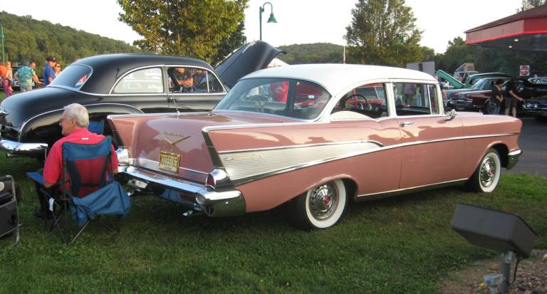 A 1957 Bel-Air is in attendance. The car's color is Canyon Coral.