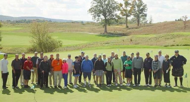 Member Appreciation Tournament Championship golfers gather on the putting green for a group photograph.