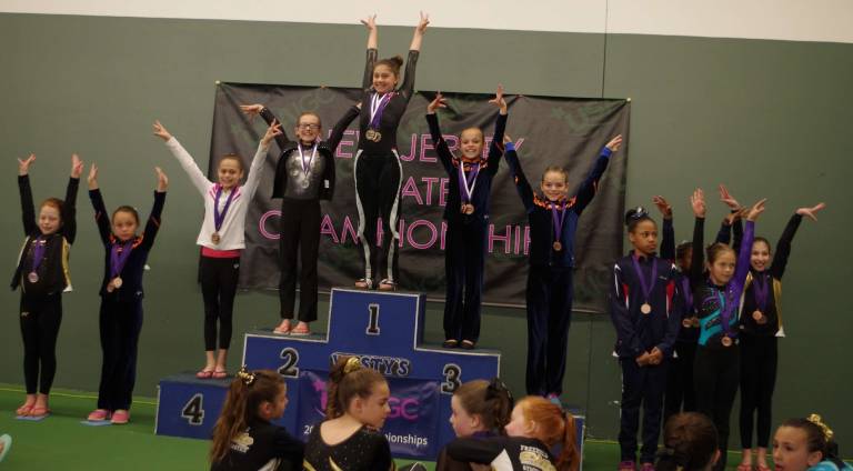 Gymnast Sarah Philback Hardyston is in the top spot on the medal stage.