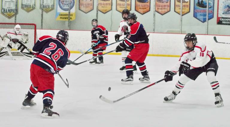 West Morris Mendham's Cameron Weil (26) hits the puck towards the goal post as High Point -Wallkill Valley's Antonio Ciasullo tries to block in the first period.