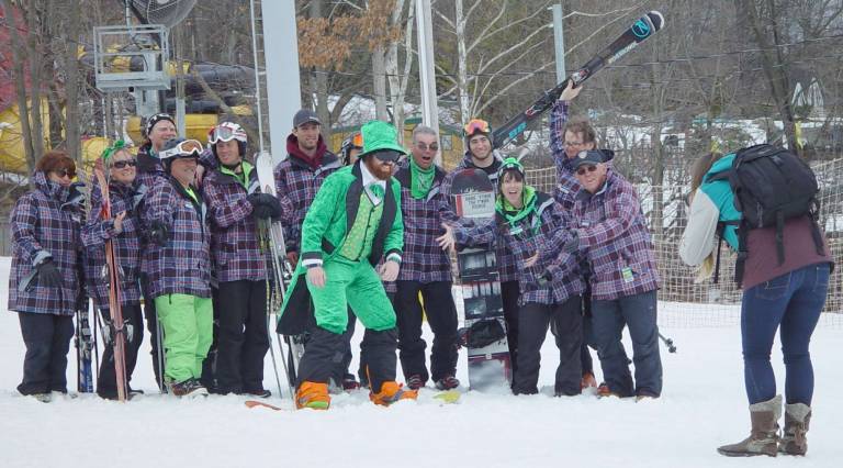 Mountain Creek photographer Lauren Scrudato, right, takes a photo of the Mountain Creek Snow Sports Staff celebrating St. Patrick&#xfe;&#xc4;&#xf4;s Day.