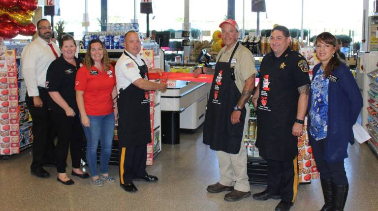 From left, Paul Fiorentino, Robin Harvey, Amanda Pierce, Sheriff Mike Strada, Assemblyman Parker Space, Lt. Lawrence Beller and Suzanne Des Rochers chipped in at the Newton ShopRite.