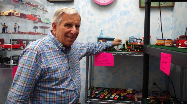 Tom Beccari has been in the auto business all his life, so the rear room of the shop has automotive memorabilia with collectable miniature cars.