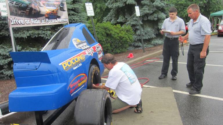 Bruce Sibel and his son time a contestant in the last Pit Stop Challenge event.