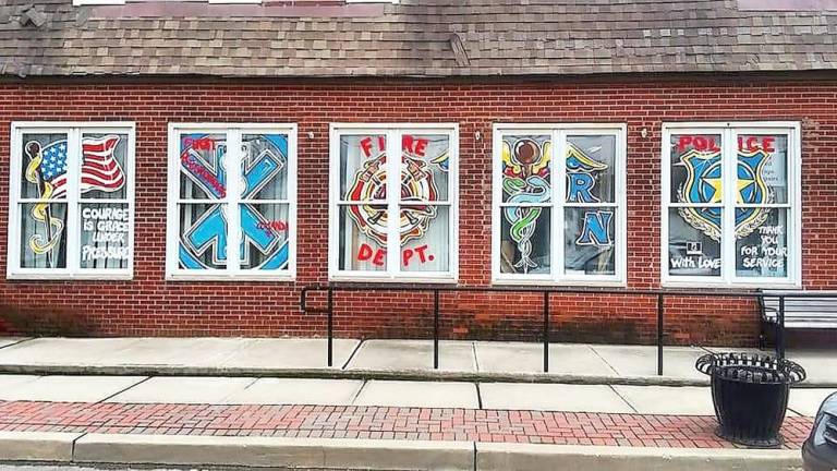 Bathing Beauties, in Ogdensburg, honored frontline workers by having Lonsky paint its windows accordingly