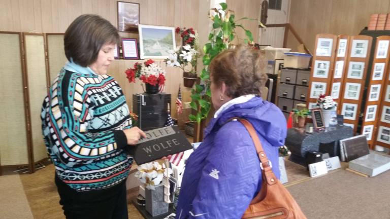 Nancy Bookbinder (left) speaks with resident Laura Steiger about a memorial.