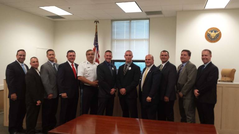 Hamburg police sergeant resigns Hamburg Sgt. Christopher Nichols, sixth from left, is shown after being sworn into his new position at the Maywood Police Dept. He will resign from Hamburg effective July 1.
