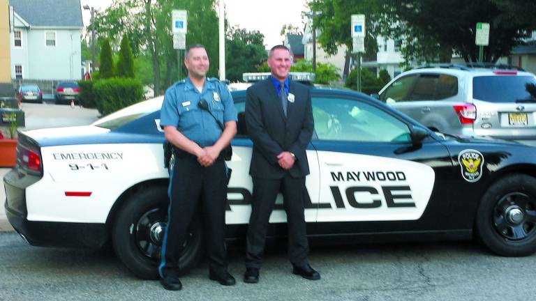 Hamburg Sgt. Christopher Nichols, right, is shown in front of a Maywood police cruiser after being sworn into the department on Tuesday.