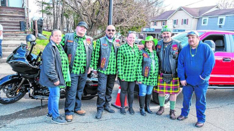 Members of the Knights of Inferno Motorcycle Club pose before the parade.