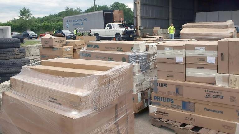 A line of cars behind several pallet loads of fluorescent bulbs (File photo by John Church)