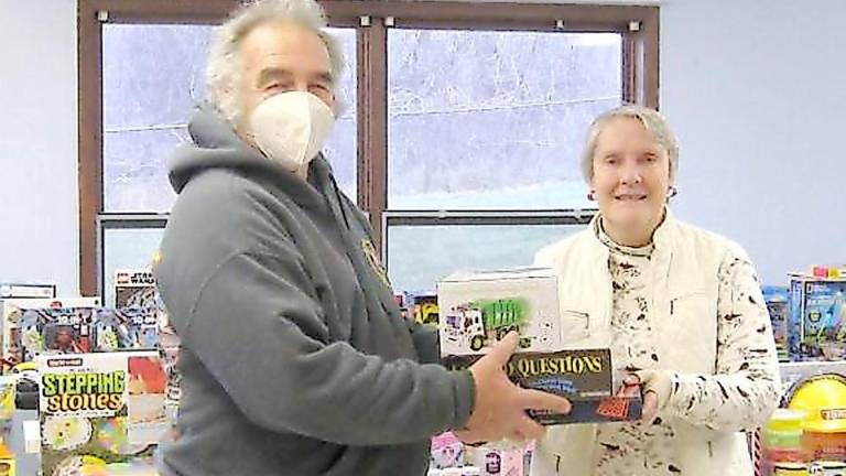 Toy drive organizer Bob Winter helps volunteer Dawn Schofer organize the donations at last year's event (Photo by Janet Redyke)