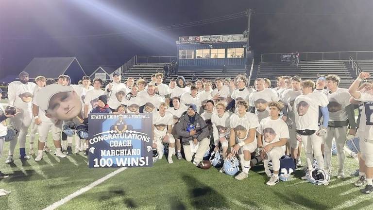 The Spartan varsity team celebrating their advancement to the semifinals and their coach’s 100th win wearing their “Marsh” shirts (Photo provided)