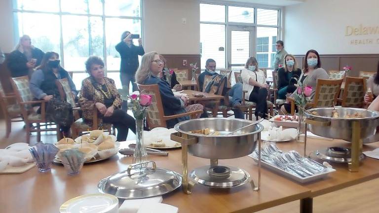 After enjoying a sumptuous buffet, people gathered to hear dignitaries speak. (Photo by Frances Ruth Harris)