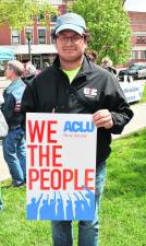 Eric Cortes holds a sign supporting the ACLU.
