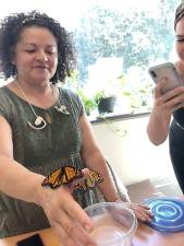 Jennifer Nunez, Horticulture Science (left), admires butterfly while Taylor Austin, Agriculture Business, takes a photo. (Photo provided)