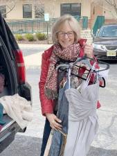 Local business owner Sherri Cecchini drops off prom dresses at Project Self-Sufficiency’s ‘Sister-to-Sister’ Prom Shop. (Photo provided)