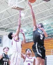 Wallkill Valley's Gavin Solano raises the ball towards the hoop during a shot. Solano scored 25 points.